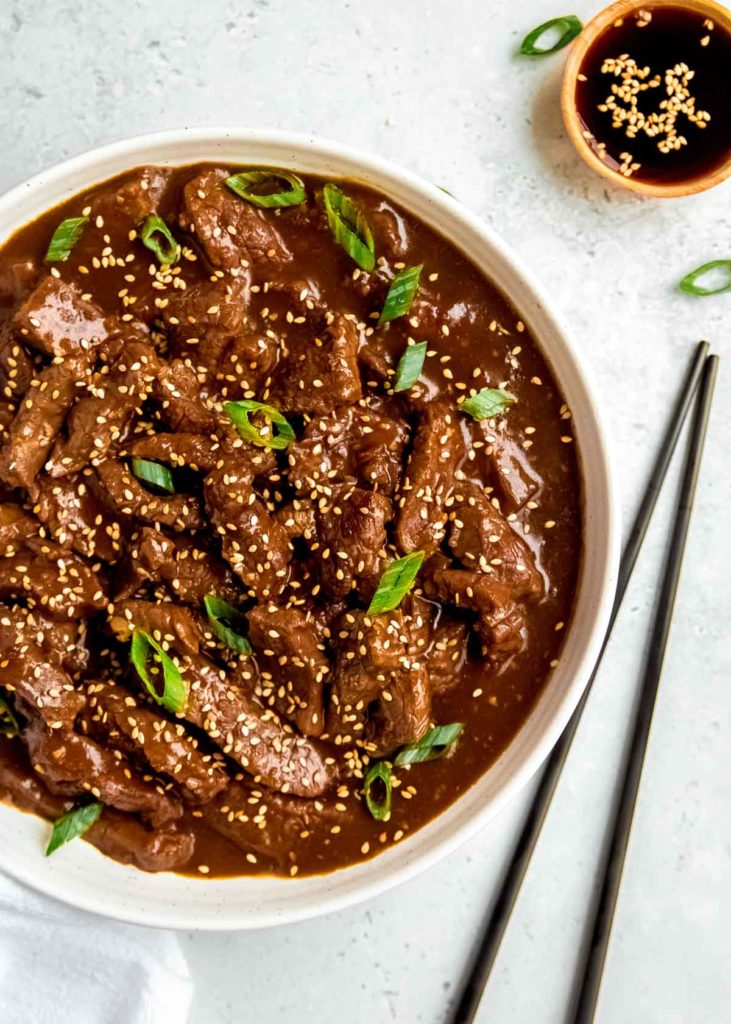This delicious Instant Pot Mongolian Beef is a quick, filling meal that reheats well! Tender flank steak in a smooth, salty-sweet sauce is pressure cooked to juicy perfection.
